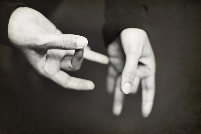 Two hands forming a word in sign language.